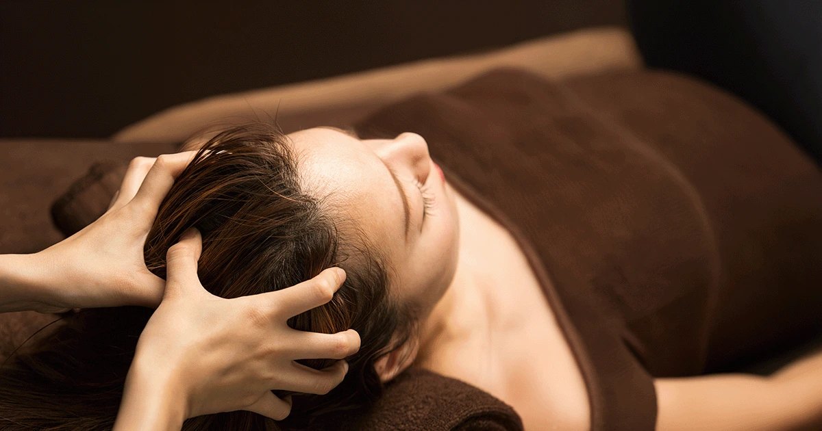 A women in salon doing her regular scalping massage