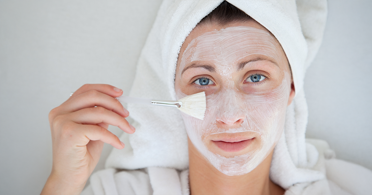 A woman applying rice flour and yoghurt face pack