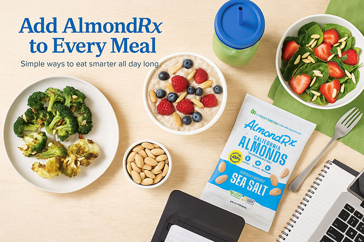 Flat-lay of almond-infused meals including oatmeal with berries, roasted vegetables, and salad topped with blanched AlmondRx almonds, alongside a Sea Salt AlmondRx pack and work essentials.