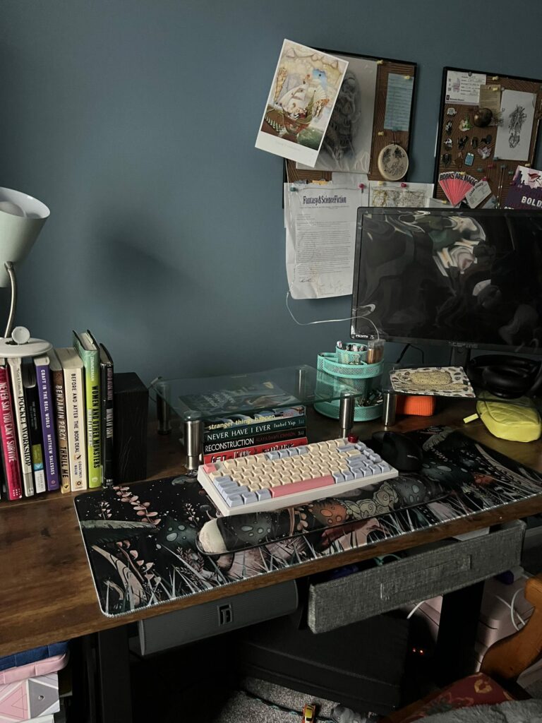 A desk in a room with a lot of things on it.