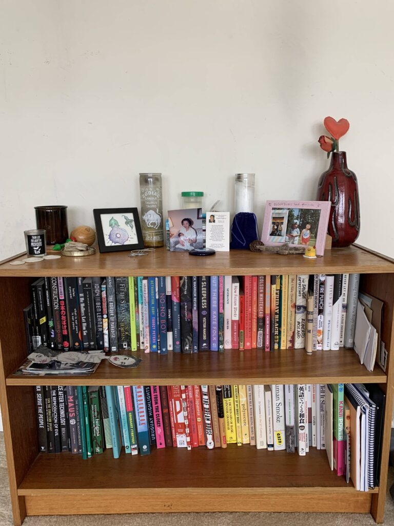 a wooden bookcase with a lot of books on it.