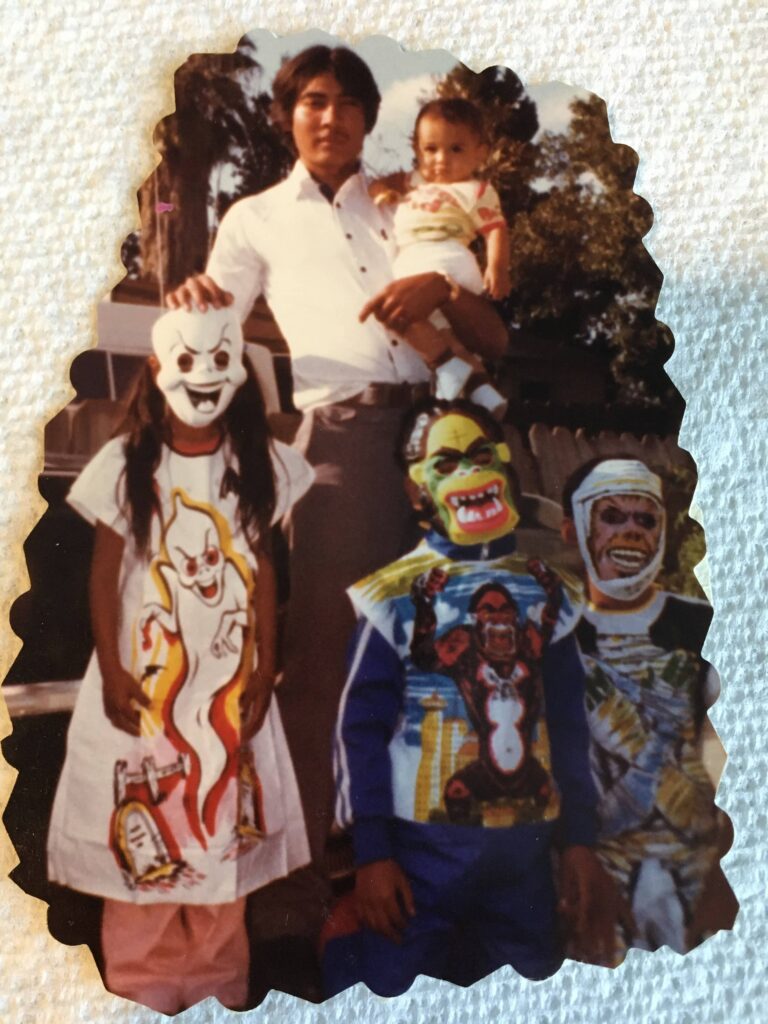 a man and two children wearing costumes.
