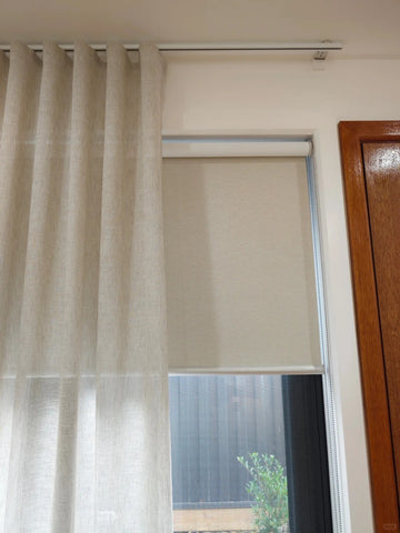 Combination of easeease blackout roller blinds and sheer curtains, offering ambiance and day-night functionality with light filtering and blackout capabilities.