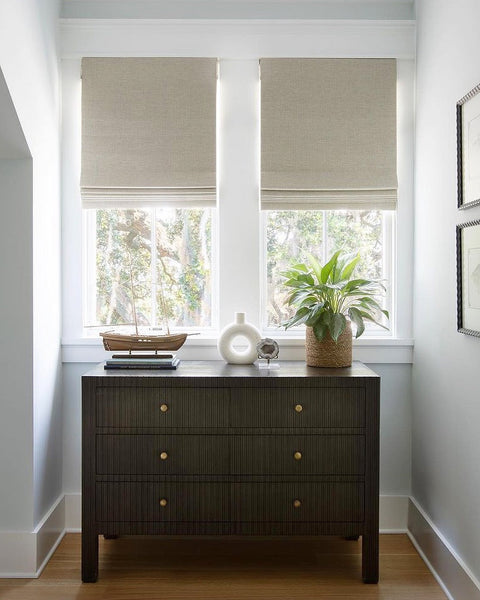 Roman Shades are thick enough to stop the glare and keep your room cooler, plus they look really classy when folded up.