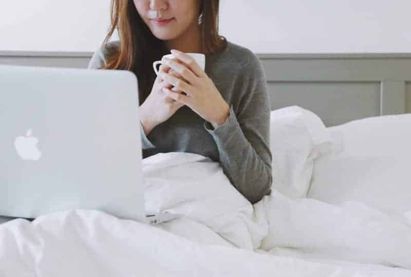 Woman working comfortably on an adjustable bed mattress Woman working comfortably on an adjustable bed mattress