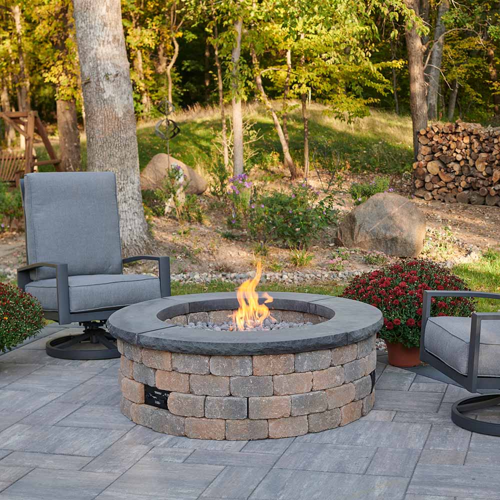 DIY outdoor gas fire pit enclosure kit installed on a patio