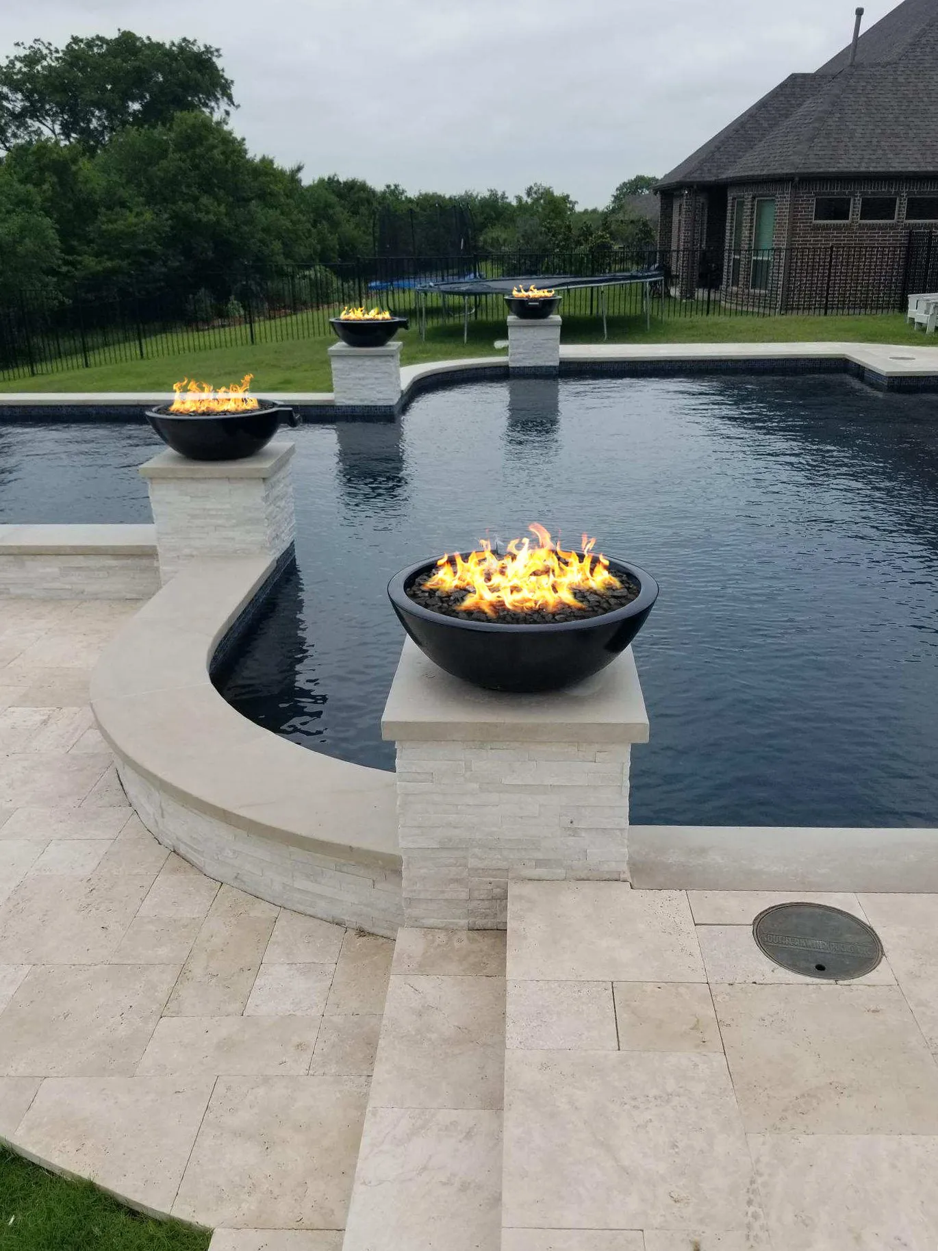Fire bowls installed near a pool