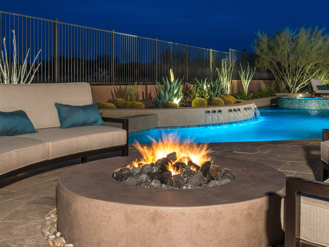 Poolside fire pit idea near luxury pool