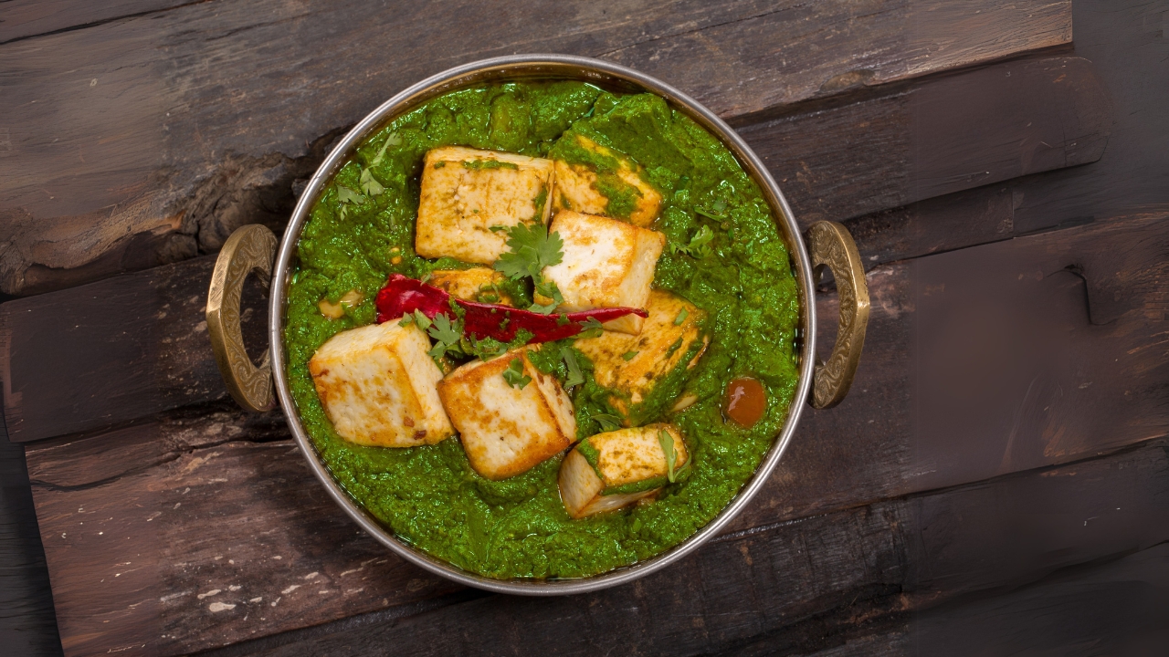 palak paneer served in a copper bowl