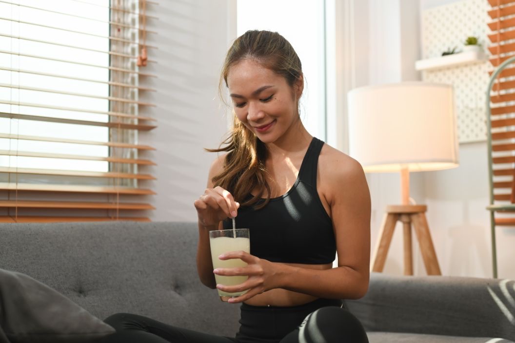 Women taking workout supplements, such as collagen. 