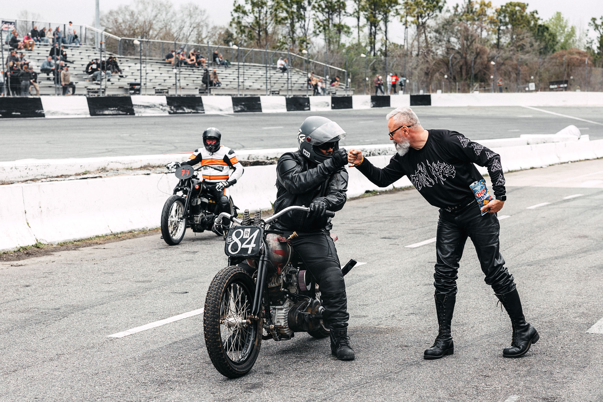 Two motorcyclists exchange a fist bump before riding, capturing the camaraderie, encouragement, and sense of community that many riders discover during their first year on two wheels.