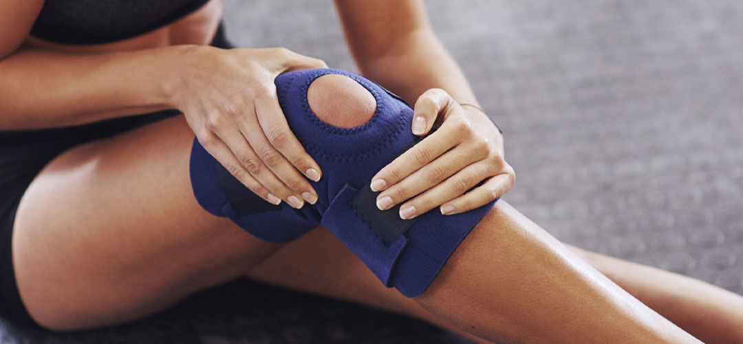 lady fixing a knee support to her leg