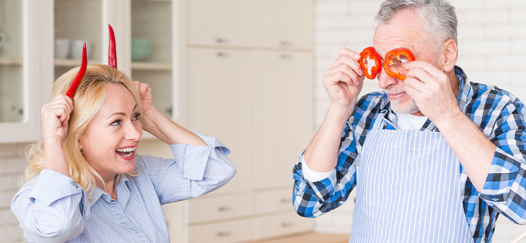 middle age couple having fun in kitchen