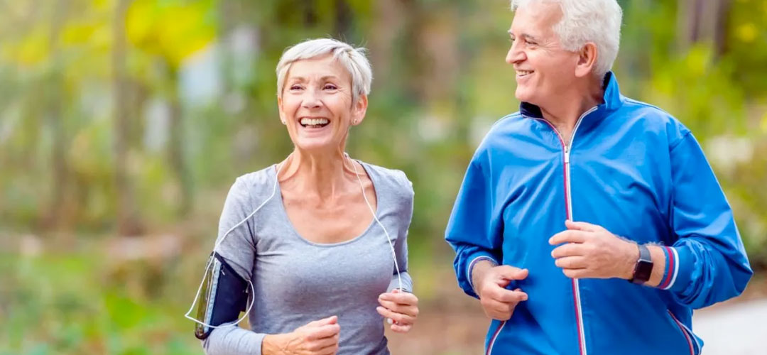 Middle age couple on a run together in the park