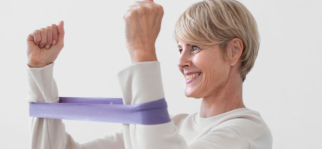 mature lady using Resistance Bands at home