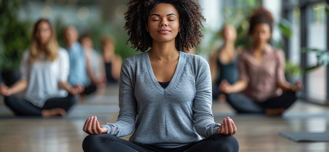 woman sitting in yoga class deep breathing