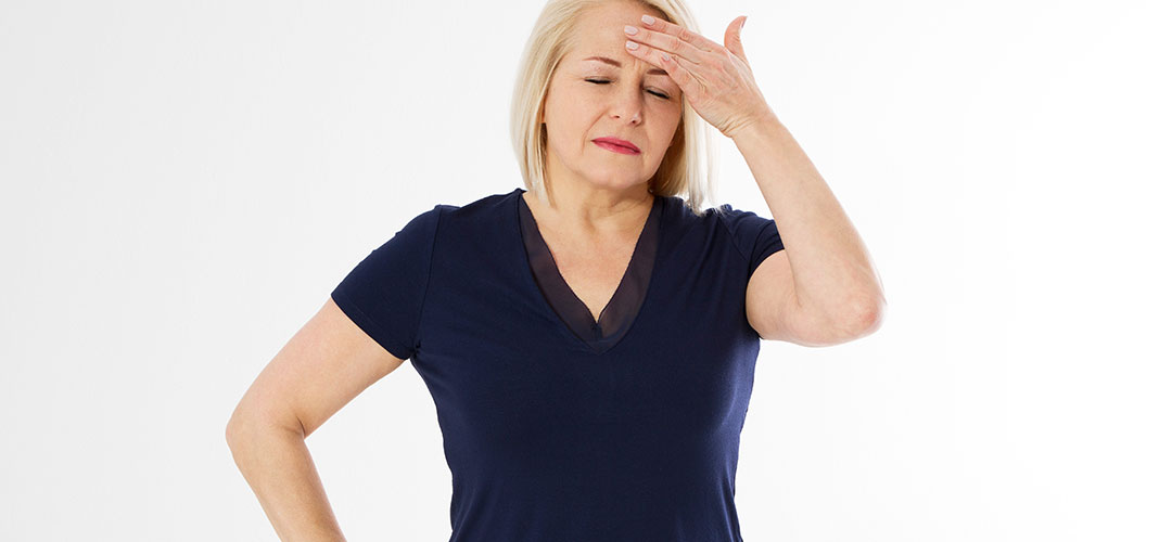 Lady holding head as feeling dizzy