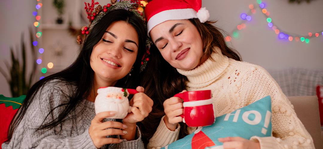 friends enjoying a cosy hot chocolate together at christmas
