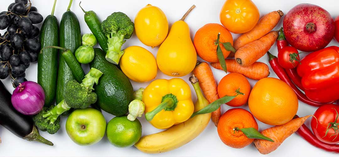 Selection of fruit and veg on white table