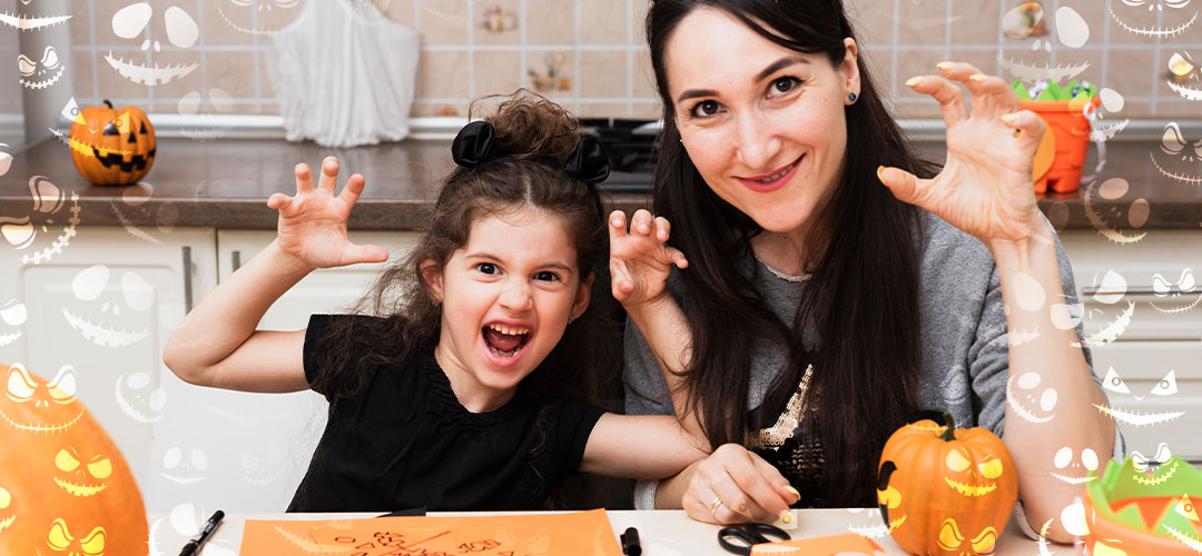 front-view-mother-daughter-looking-camera being creative at halloween