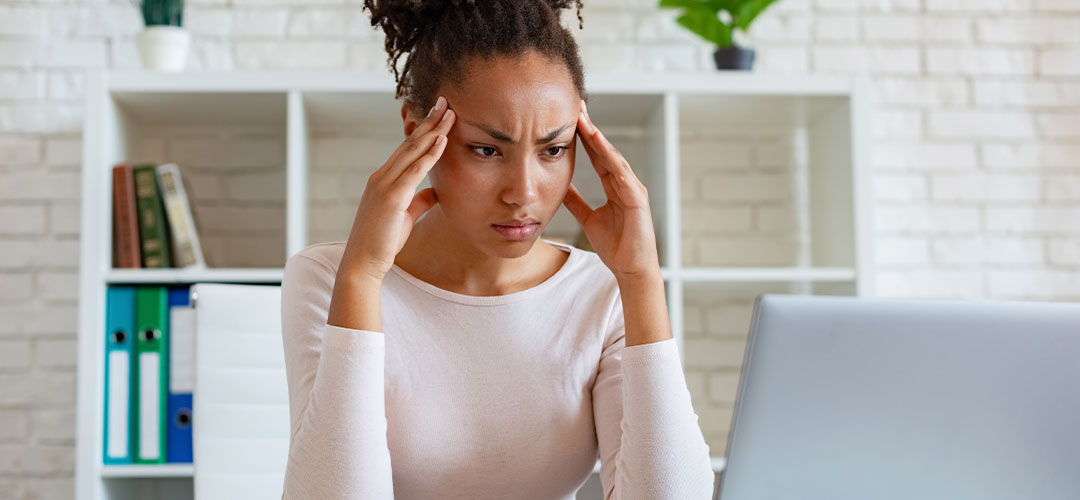 lady suffering with a headache due to dehydration