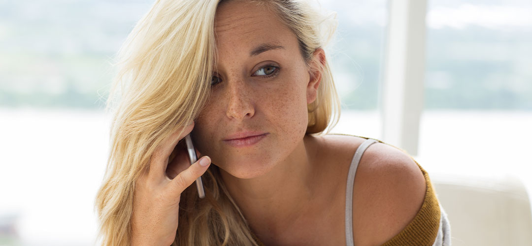 Female with healthy hair on phone