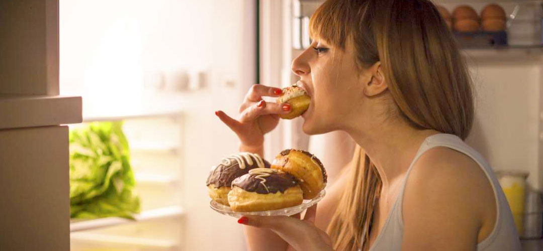 lady in fridge eating cake at night