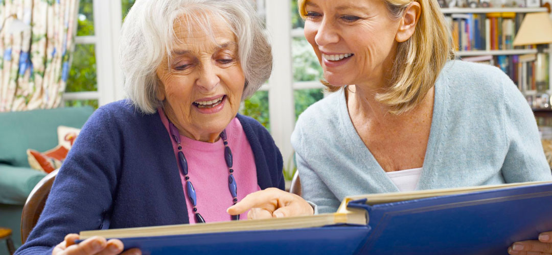 mother and daughter looking at old photographs