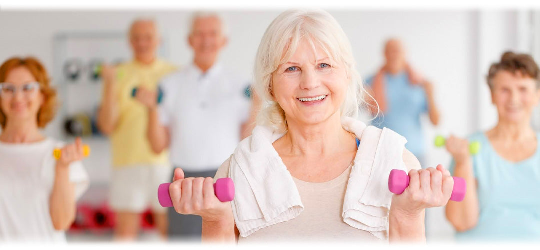 Women in an exercise class holding small dumbells