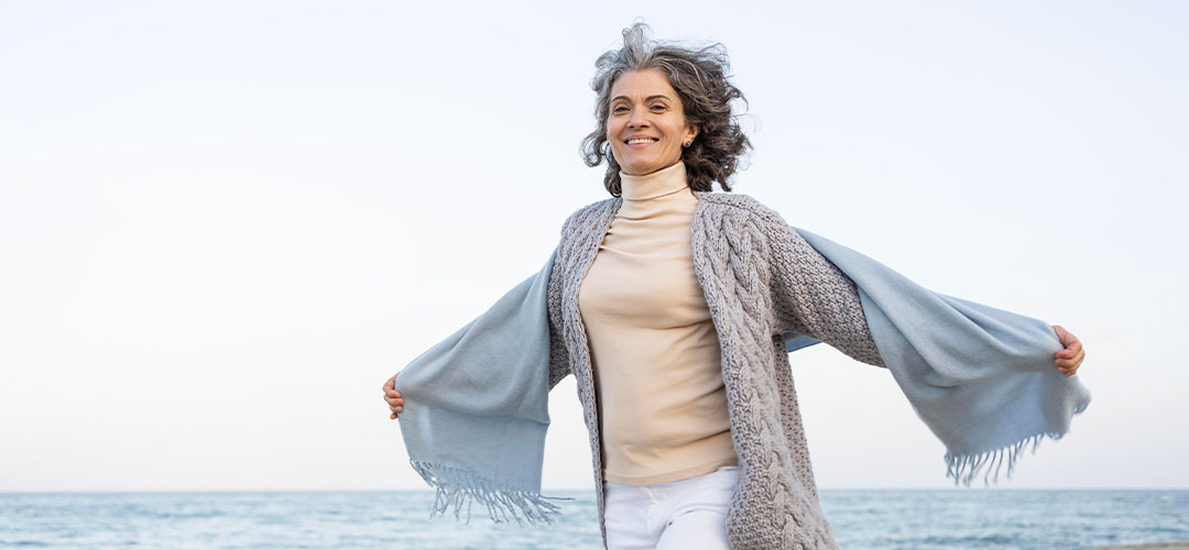 lady on the beach celebrating longevity