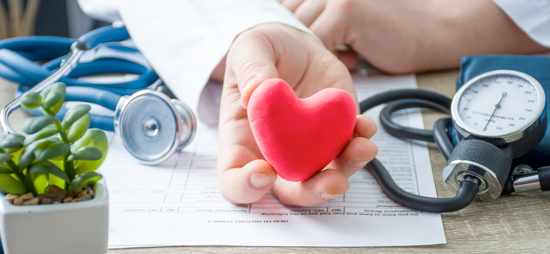 Doctor holding clay heart in consultation