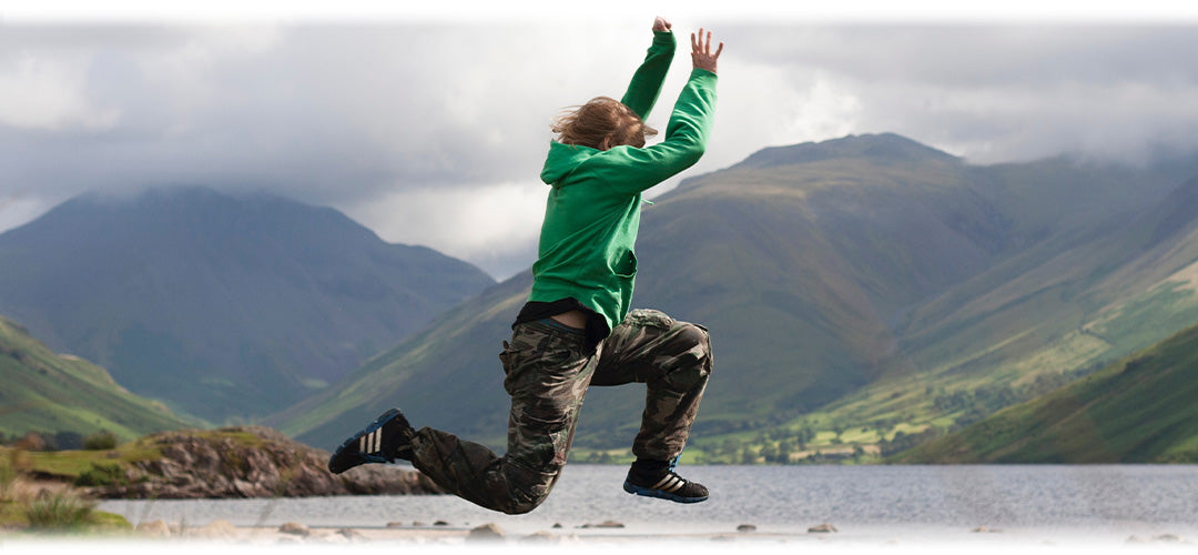 A person full of energy jumping into a lake