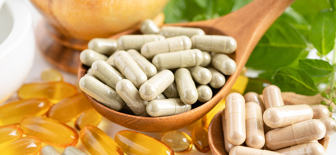 section of supplements with some on wooden spoon