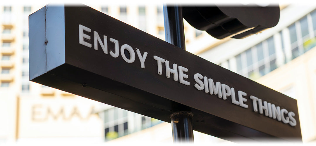 A street sign which reads "enjoy the simple things"