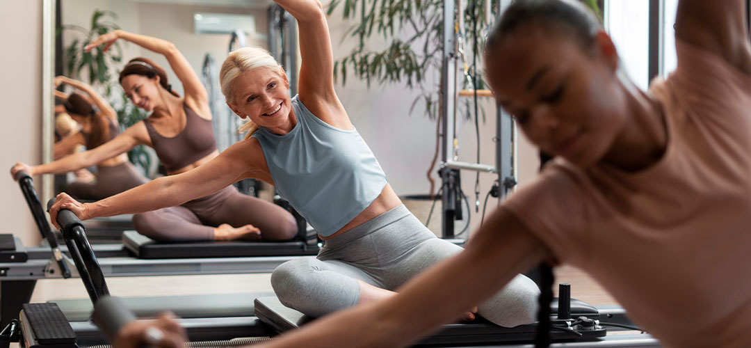 people-pilates-reformer-class-exercising-their-bodies