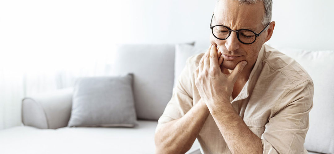 middle age man at home suffering from Sensitive Teeth