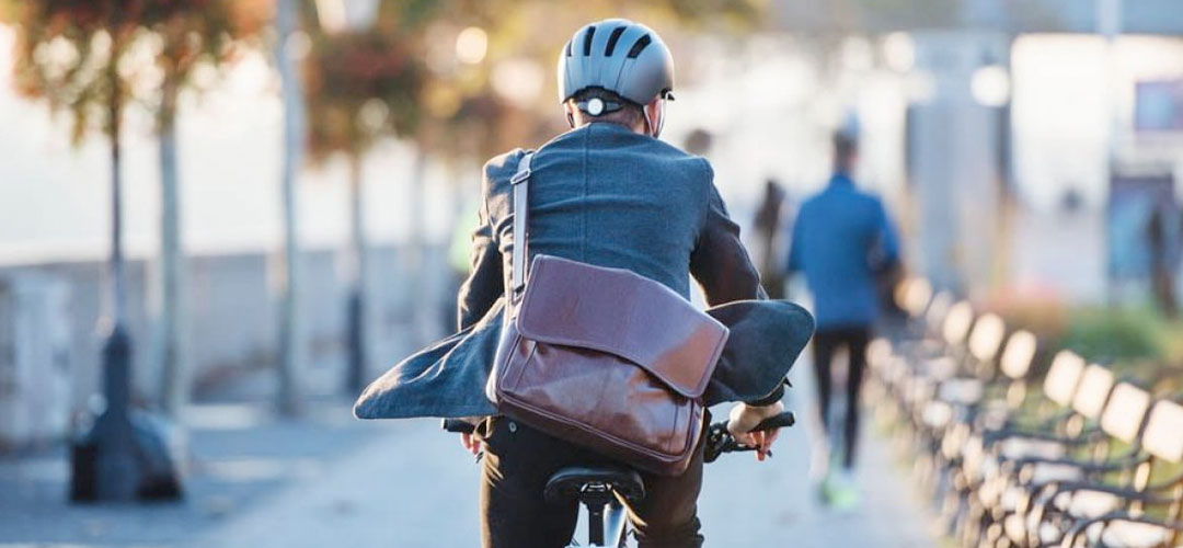man cycling to work in a suite
