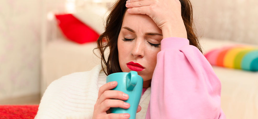 lady having hot flushes sitting on couch