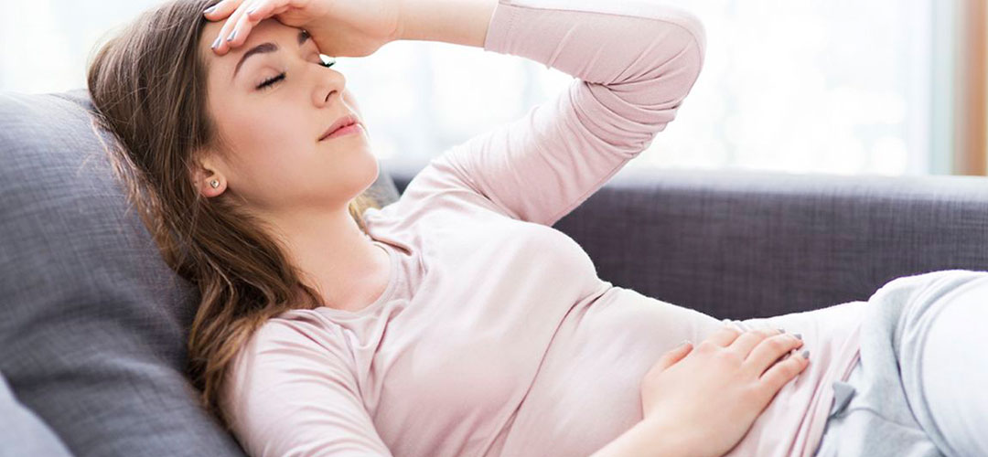 lady feeling bloated on the couch