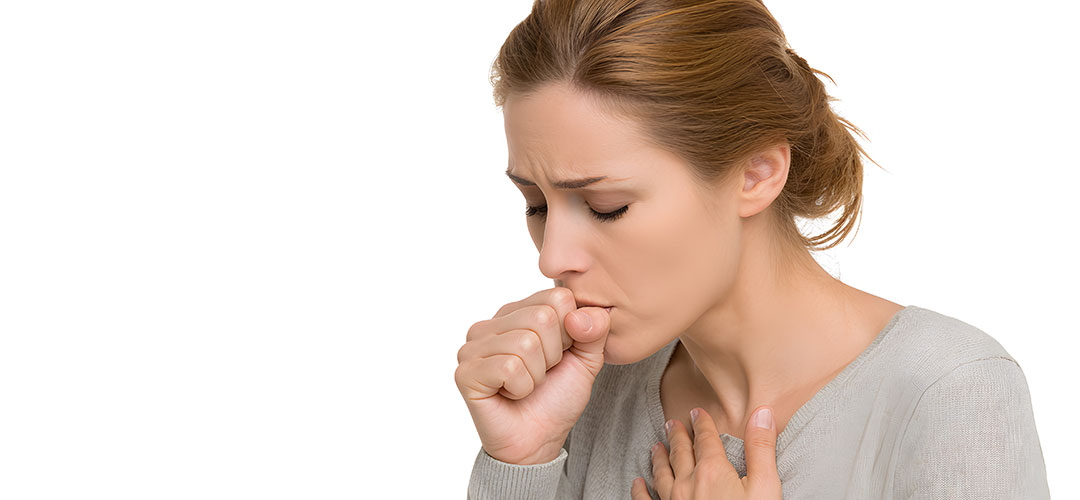 a-woman-is-holding-her-chest-and-coughing