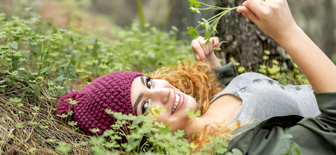 smiley-woman-laying-grass