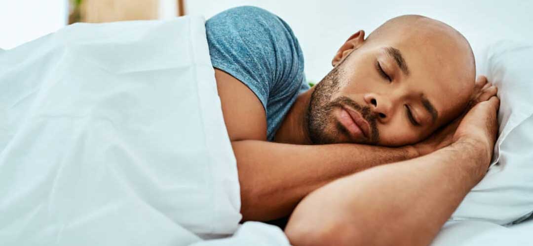 man asleep in bed