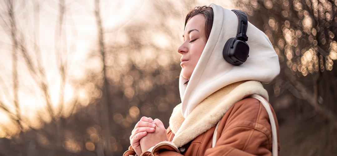 woman listening to her motivational playlist while out walking