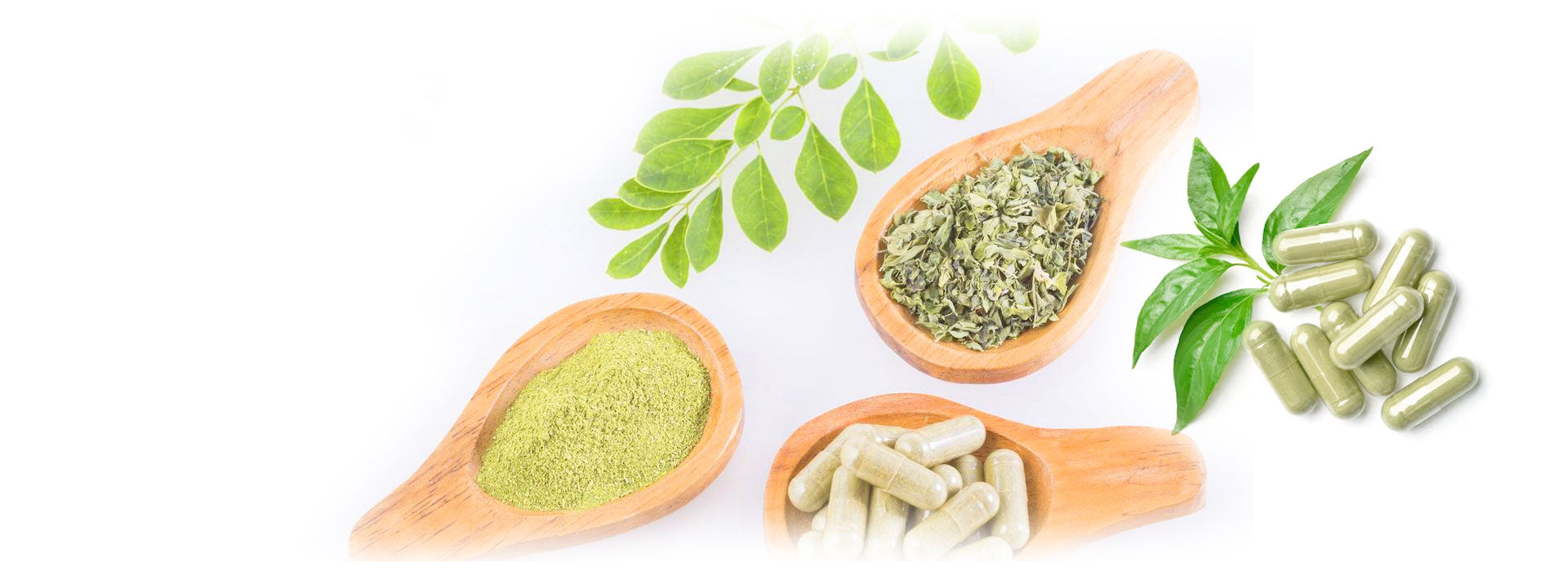 Herbs on a wooden spoon and capsules scattered around