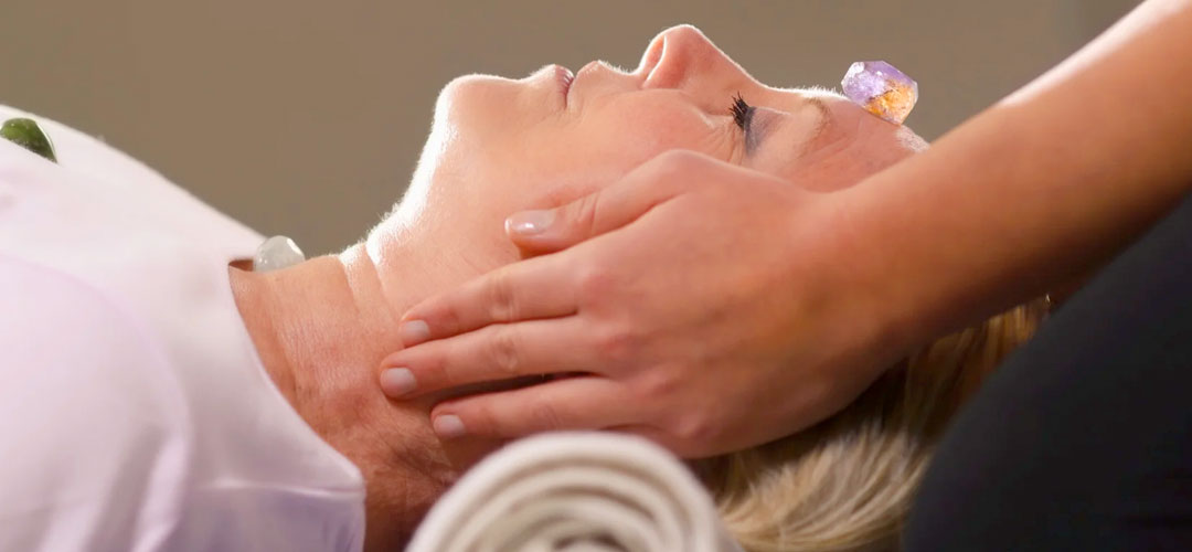 lady having crystals laid on her forehead