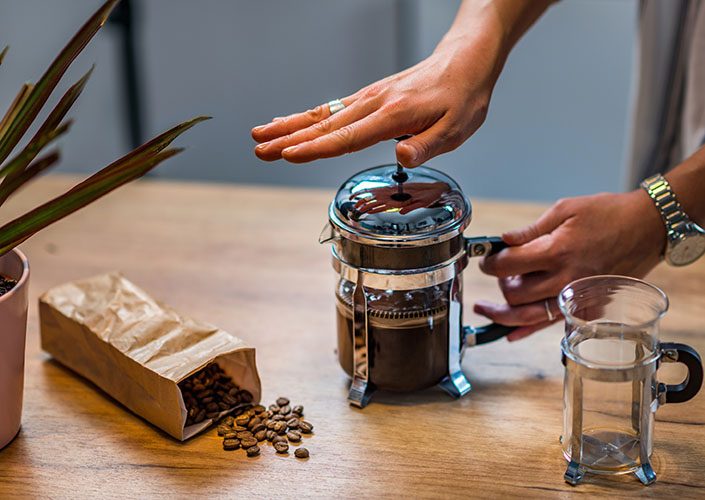 french press coffee beans wooden counter