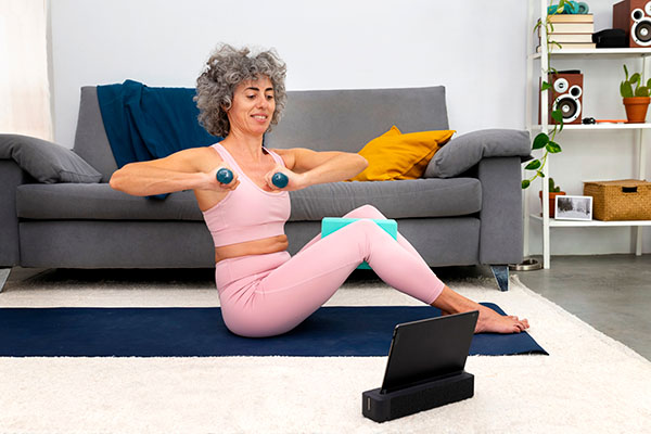 midlife woman exercising with dumbbells