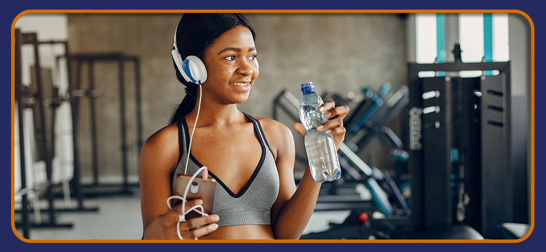 Woman with water bottle and headphones, showcasing Pro-Fit's active lifestyle.