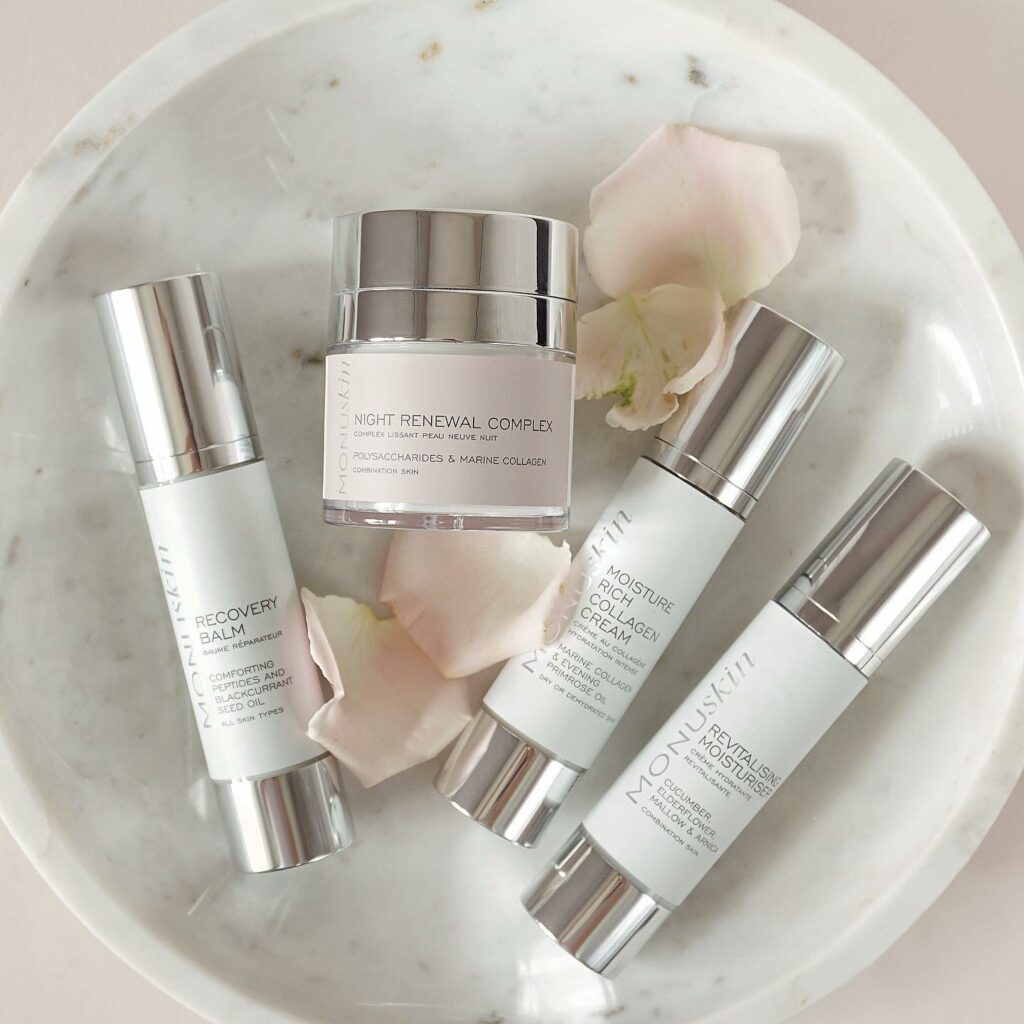 Four Monuskin products laying in a marble bowl