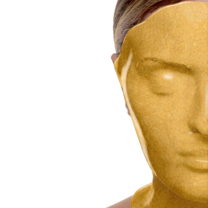 Casmara gold mask applied to the face of a lady with her eyes shut